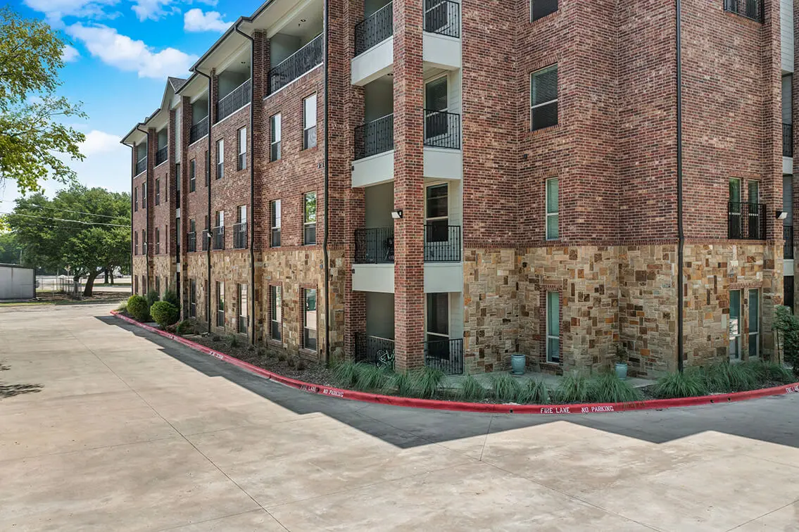 404 Industrial Park building corner with brick walls, a stone base and private balconies (2)
