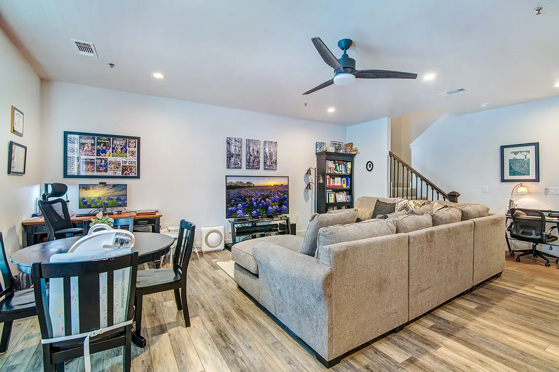 Living and dining area at 404 Industrial Park with wood look floors, a ceiling fan and stairs (4)