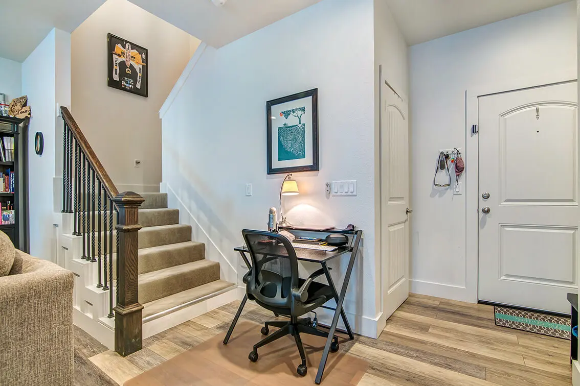 Front door and carpeted staircase inside a 404 Industrial Park apartment (5)