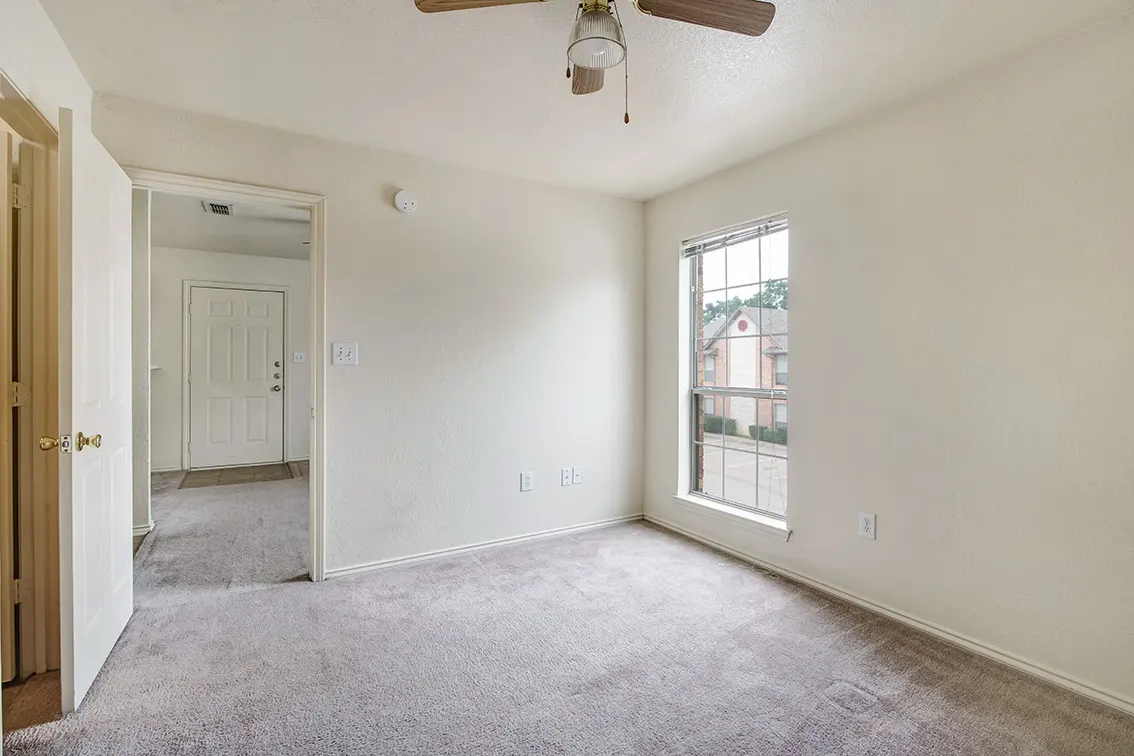 Cole Place bedroom with a ceiling fan, a window and a doorway to the living room (12)
