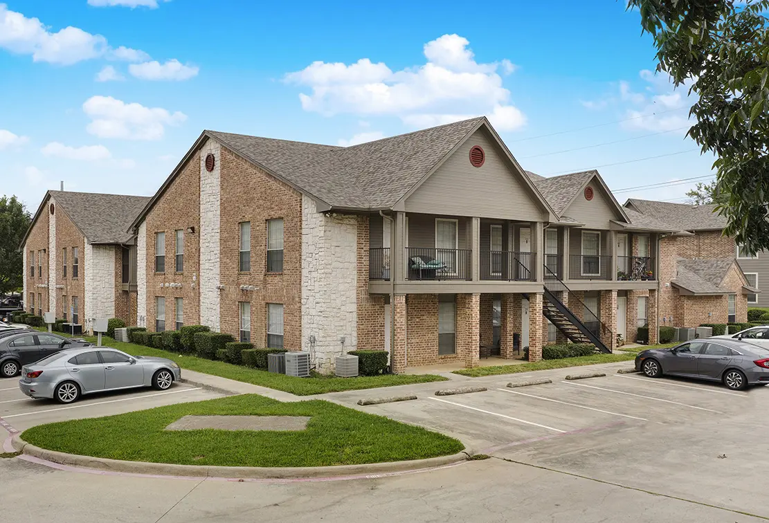 Cole Place two story brick and stone buildings with balconies, outside stairs and parking (4)