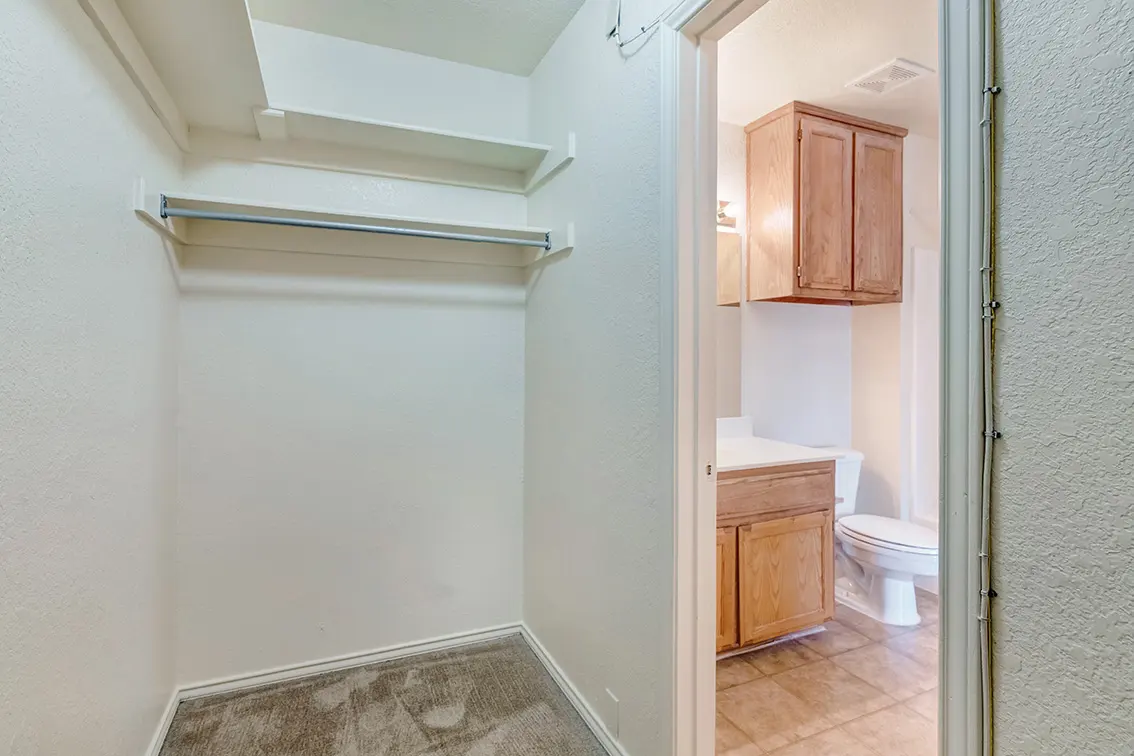 Cole Place closet with a hanging rod and shelf next to the bathroom door (11)