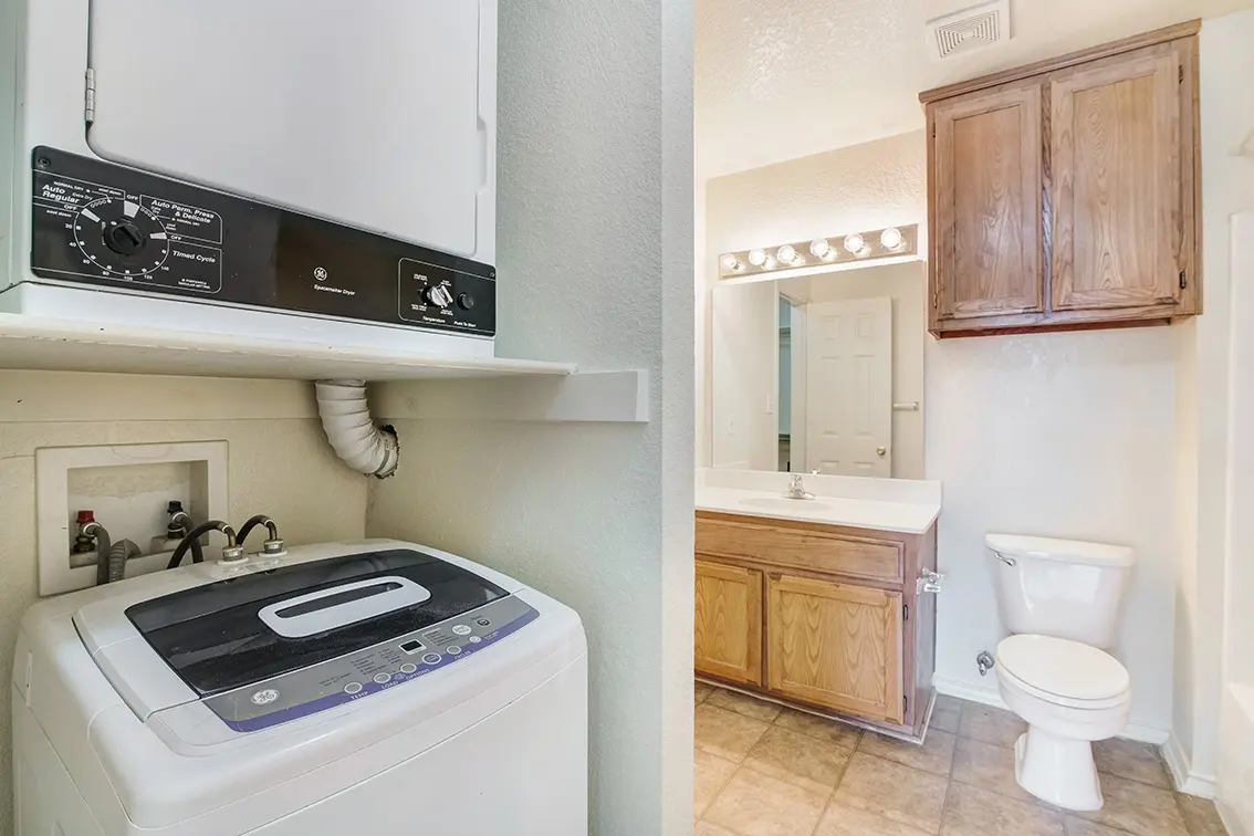 Cole Place laundry nook with washer and dryer hookups, shown beside a view of the bathroom (9)