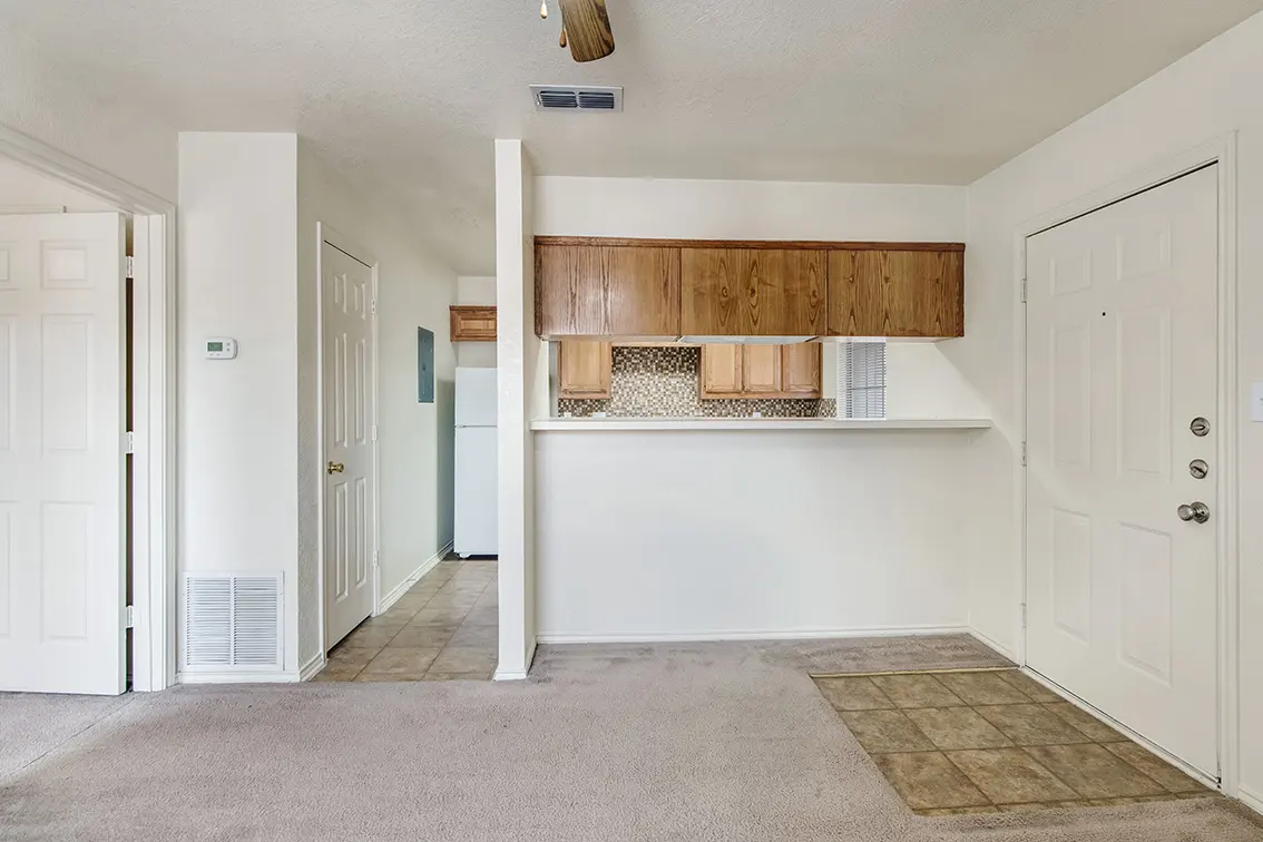 Cole Place living room with a kitchen pass-through, tiled entry and front door (6)