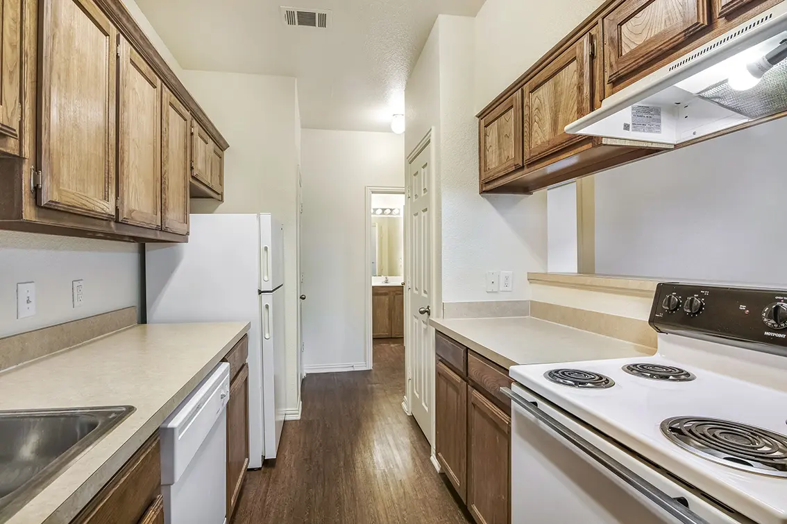 Lone Star kitchen with wood cabinets, an electric range, dishwasher and refrigerator (8)