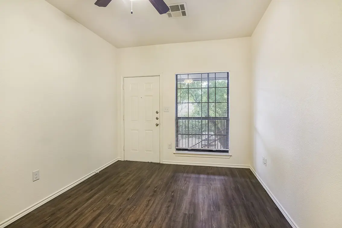 Lone Star living room with a wood style floor, a window and the front door (5)