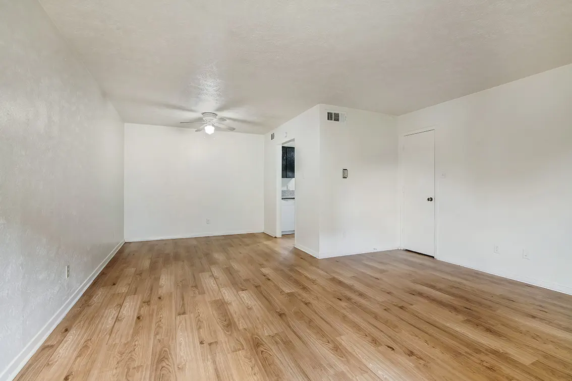 The Clusters living room with light wood style floors and a ceiling fan (6)